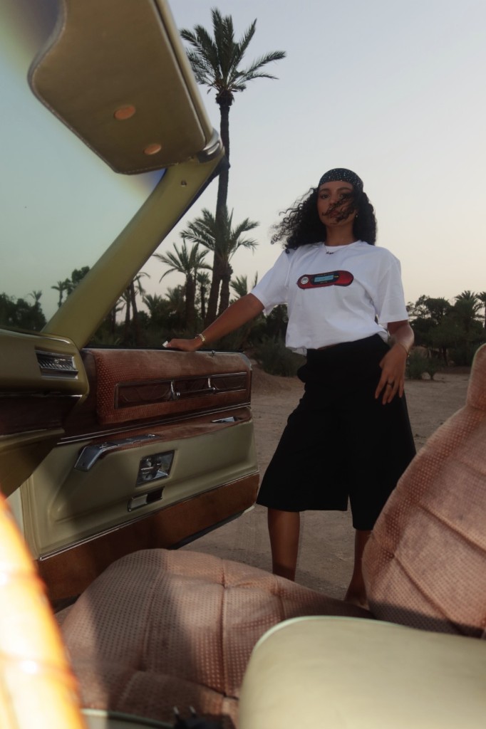 White tee at the car door